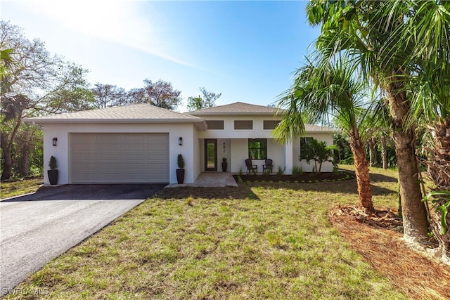 view of front of house with a garage and a front yard