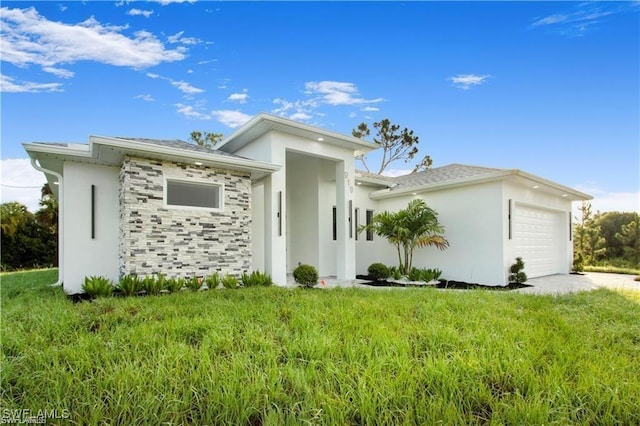 view of front of home featuring a garage and a front lawn