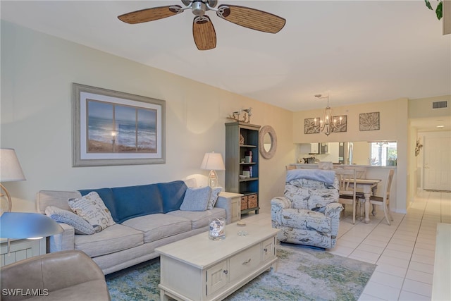 living room featuring ceiling fan with notable chandelier and light tile patterned floors