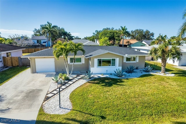 ranch-style house featuring a garage and a front yard