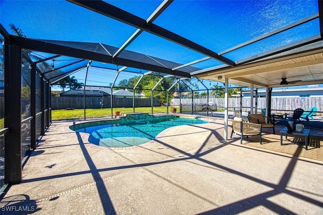 view of pool with a lanai, a lawn, ceiling fan, and a patio area