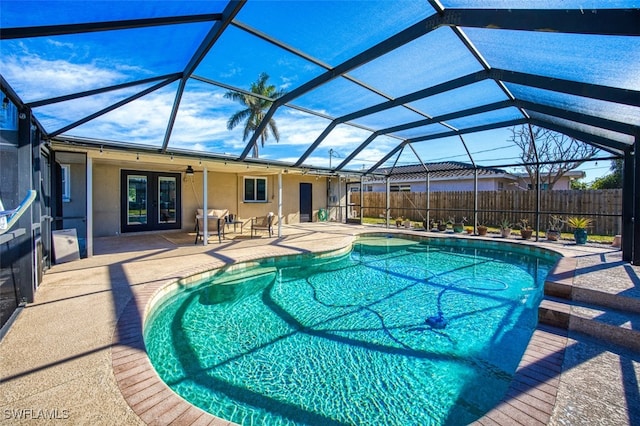 view of pool with a patio area, french doors, and glass enclosure