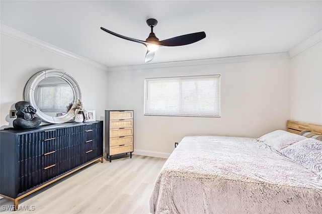 bedroom featuring hardwood / wood-style flooring, ornamental molding, and ceiling fan