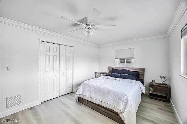 bedroom featuring a closet, ornamental molding, light hardwood / wood-style floors, and ceiling fan