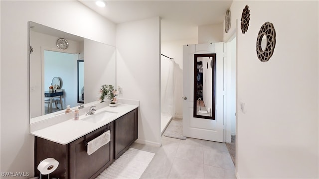 bathroom with tile patterned floors, vanity, and curtained shower