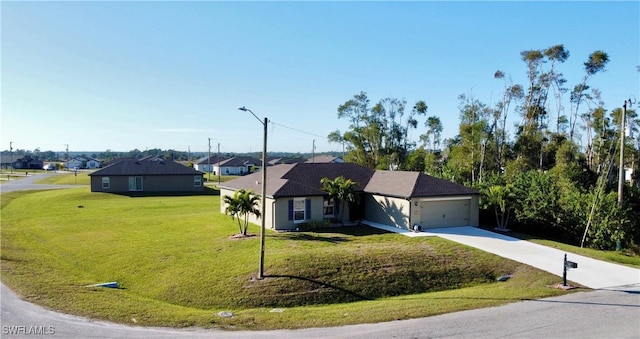 ranch-style house featuring a garage and a front lawn