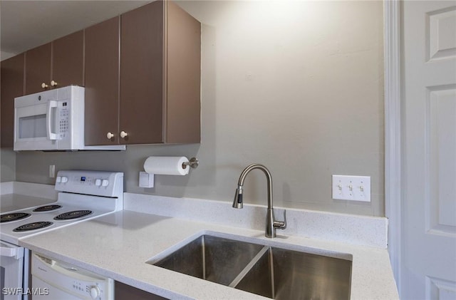 kitchen featuring sink and white appliances