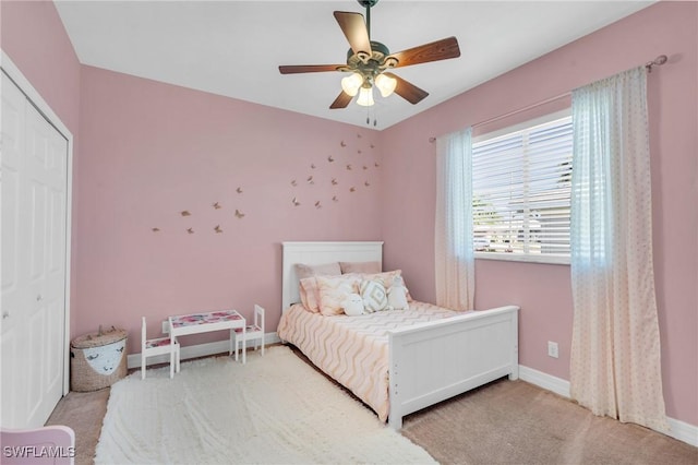 carpeted bedroom with ceiling fan and a closet