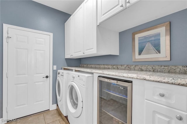 laundry room with washing machine and dryer, light tile patterned flooring, and beverage cooler