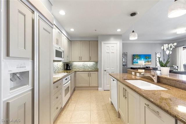 kitchen with sink, light stone counters, decorative light fixtures, light tile patterned floors, and white appliances