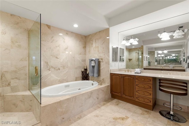 bathroom with vanity, tile walls, and separate shower and tub