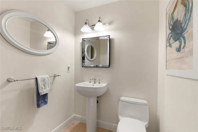 740 N Collier Blvd Unit 2-406, Marco Island, FL 34145 - bathroom with baseboards, toilet, and tile patterned flooring