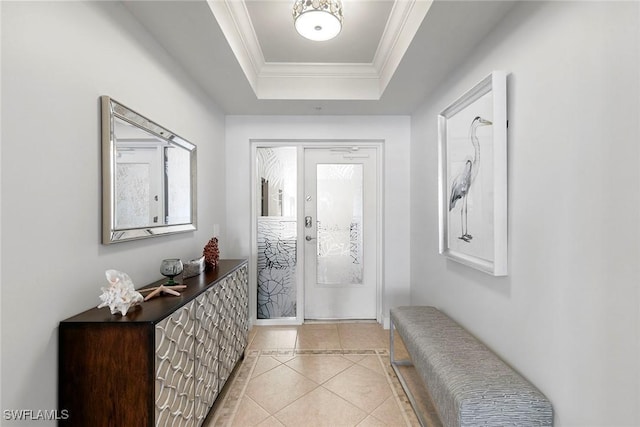 interior space featuring ornamental molding, a raised ceiling, and light tile patterned floors