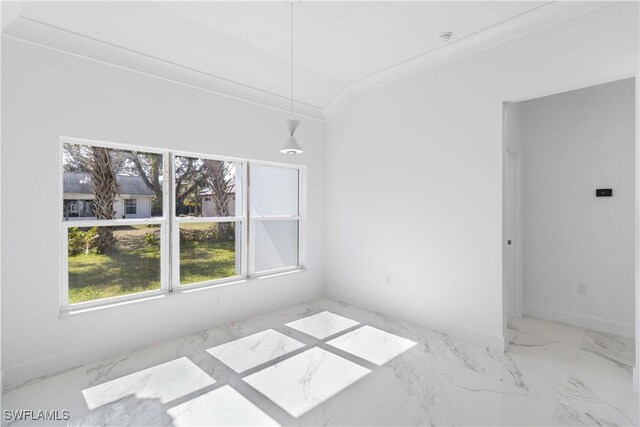 spare room with crown molding and vaulted ceiling