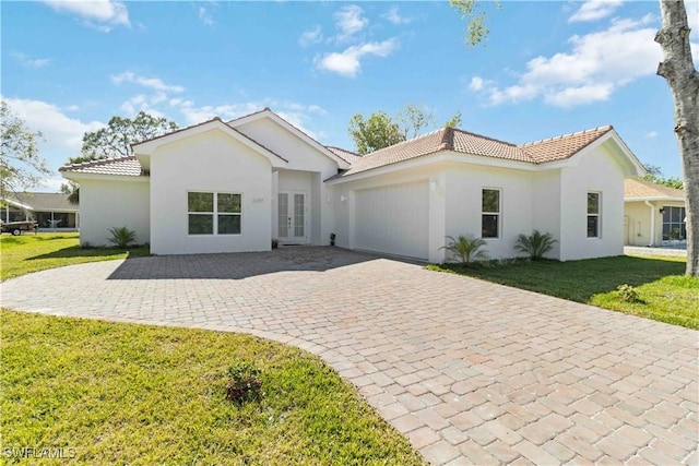 view of front of property with a garage and a front lawn