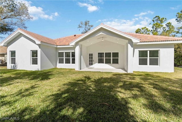 back of house featuring a patio and a yard