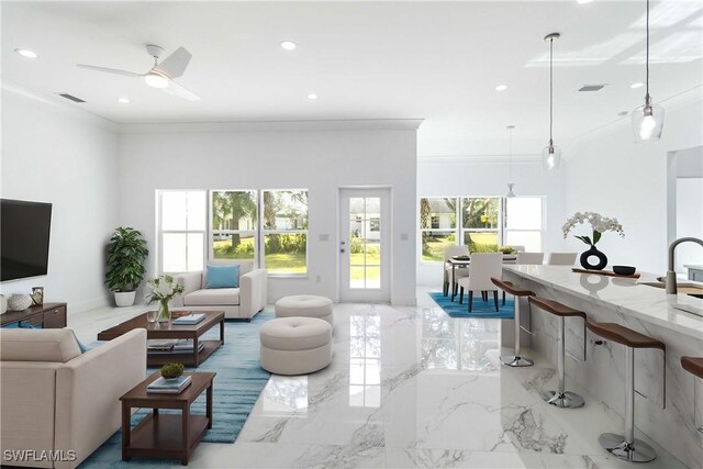 living room featuring ornamental molding, plenty of natural light, and ceiling fan