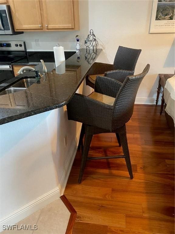 dining room featuring sink and hardwood / wood-style floors