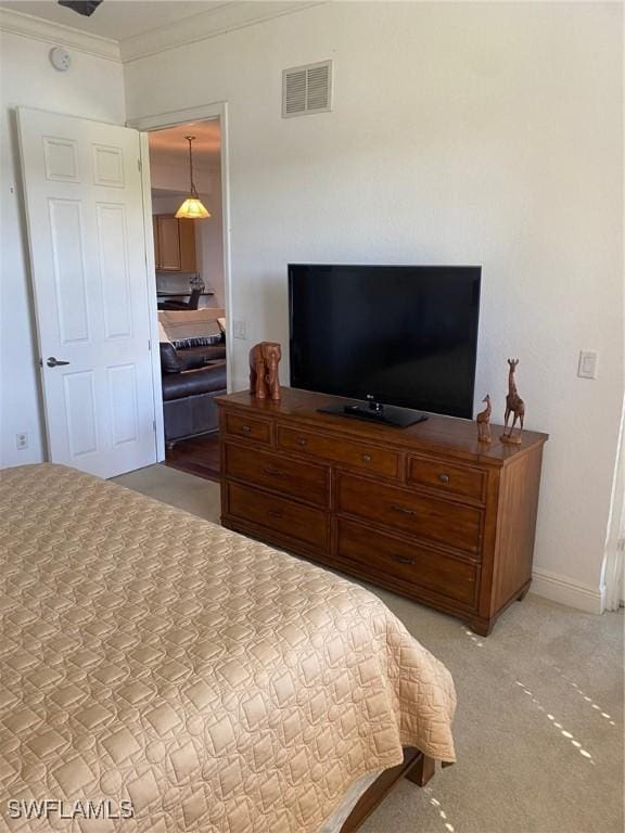 bedroom featuring visible vents, light carpet, baseboards, and crown molding