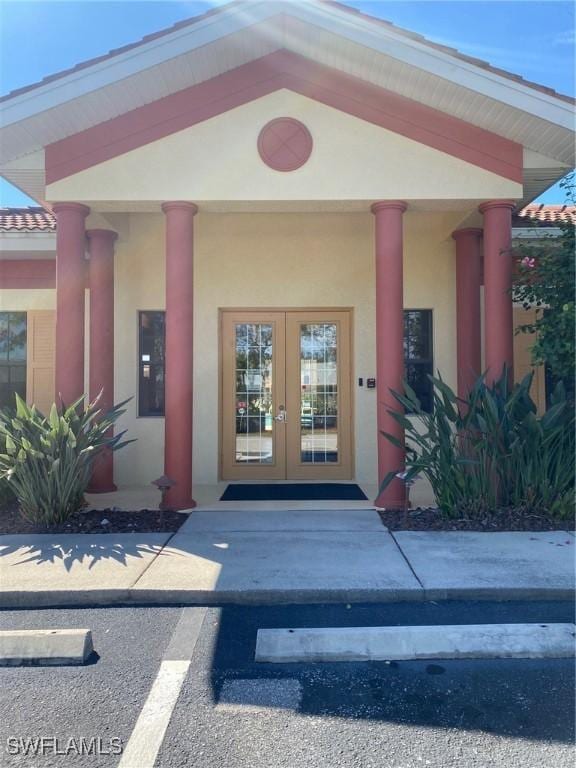 entrance to property with stucco siding and french doors