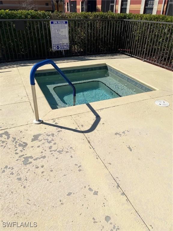 view of pool with a hot tub