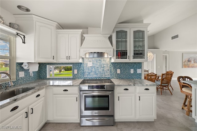 kitchen with white cabinetry, electric range, light stone countertops, premium range hood, and sink