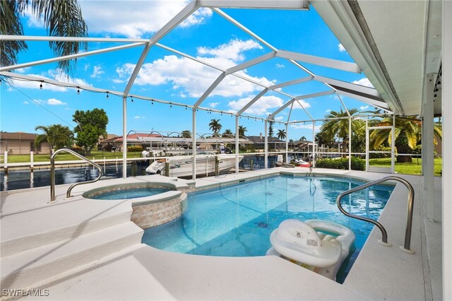 view of swimming pool featuring a patio, an in ground hot tub, and glass enclosure