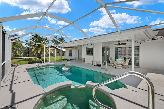 view of swimming pool with a patio area, ceiling fan, and a lanai