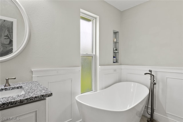 bathroom featuring vanity and a bath