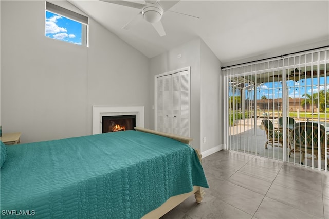 bedroom with a closet, vaulted ceiling, access to outside, and ceiling fan