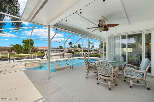 sunroom with a patio area and ceiling fan