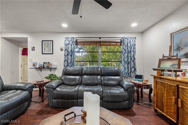 living room with dark wood-type flooring and ceiling fan