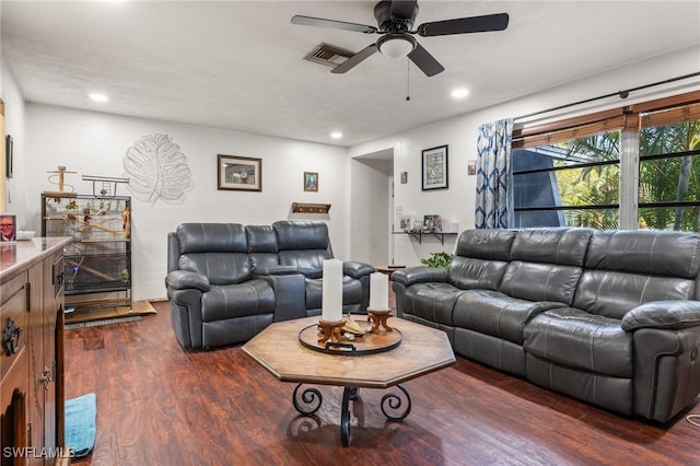 living room with dark wood-type flooring and ceiling fan