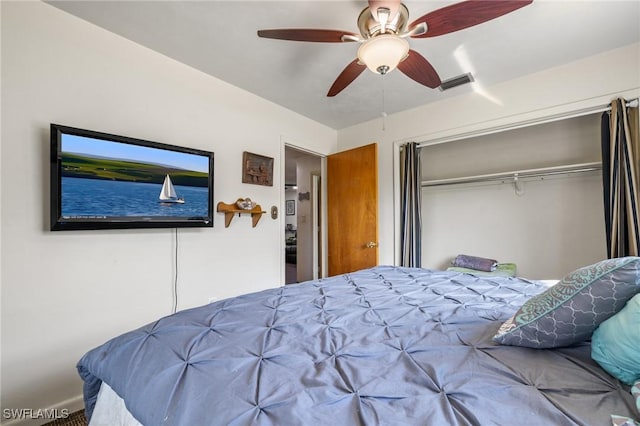 bedroom with ceiling fan and a closet