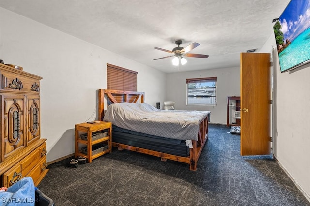 bedroom featuring ceiling fan and dark carpet