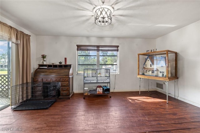 miscellaneous room with hardwood / wood-style floors and a notable chandelier