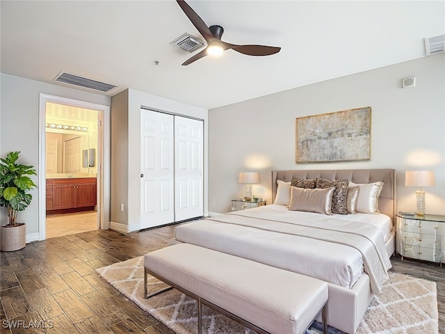 bedroom with a closet, dark hardwood / wood-style floors, ceiling fan, and ensuite bathroom