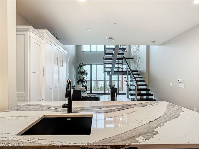 kitchen with light stone counters and sink