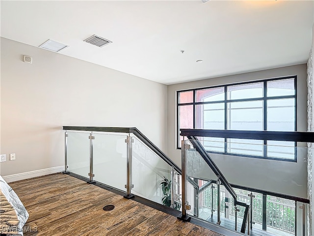 staircase with hardwood / wood-style flooring