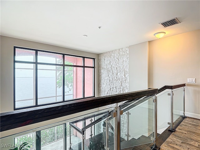 stairway featuring dark hardwood / wood-style floors and a water view