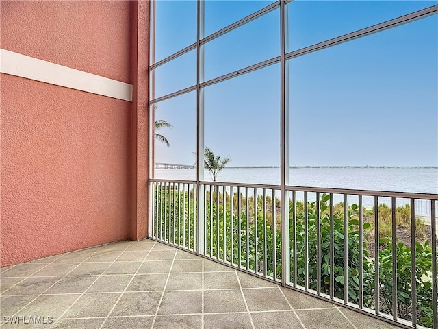 unfurnished sunroom with a water view