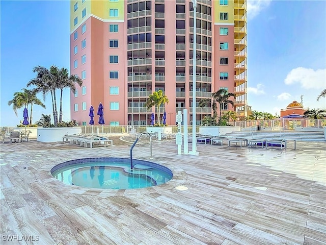 view of swimming pool featuring a community hot tub and a patio area