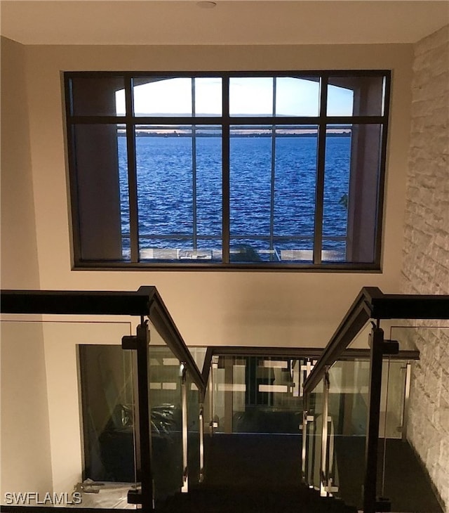 staircase featuring a water view