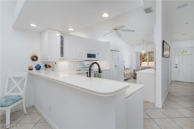 kitchen with white cabinetry, white appliances, kitchen peninsula, and light tile patterned floors