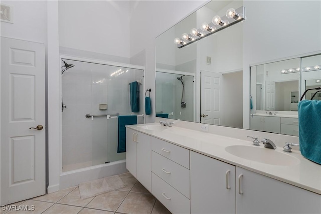 bathroom with vanity, an enclosed shower, and tile patterned flooring