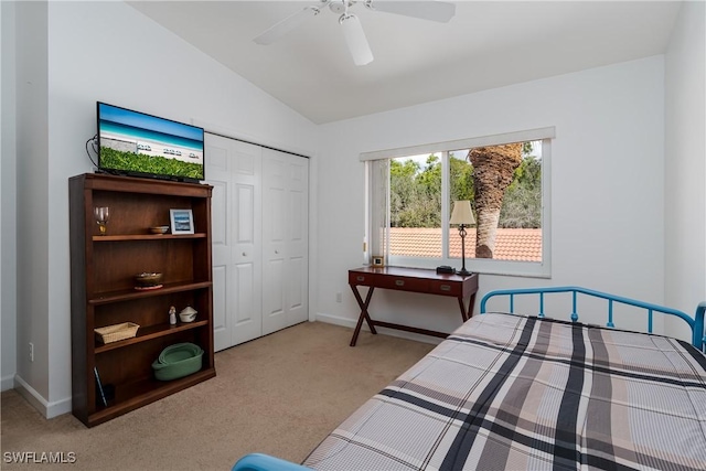 carpeted bedroom featuring vaulted ceiling, a closet, and ceiling fan