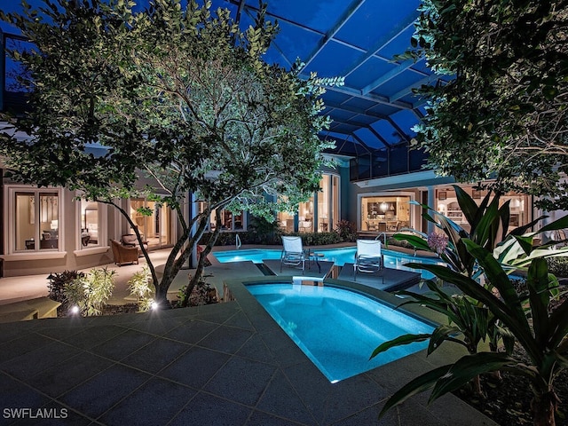 view of swimming pool featuring an in ground hot tub, a lanai, and a patio