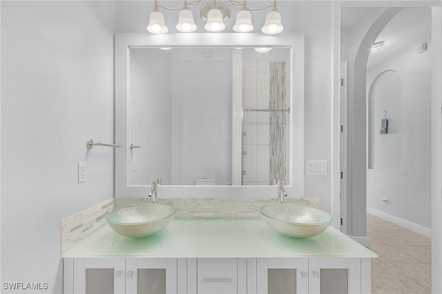 bathroom featuring vanity, tile patterned floors, and walk in shower