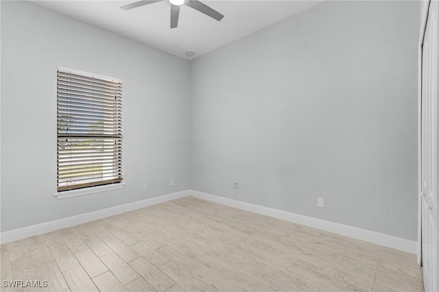 spare room featuring light hardwood / wood-style flooring and ceiling fan