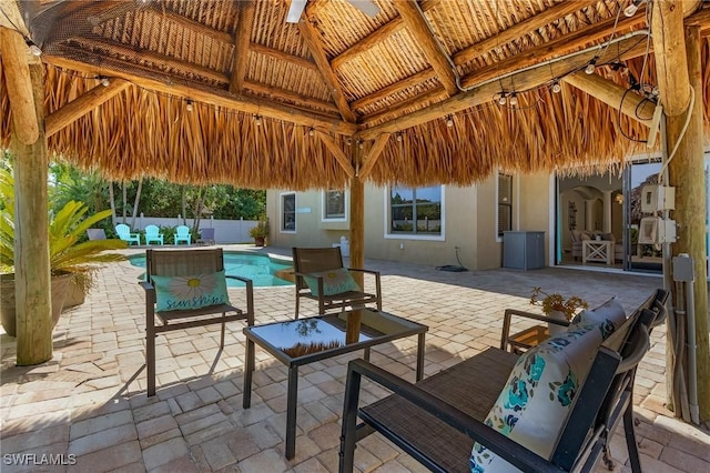 view of patio with a fenced in pool and a gazebo